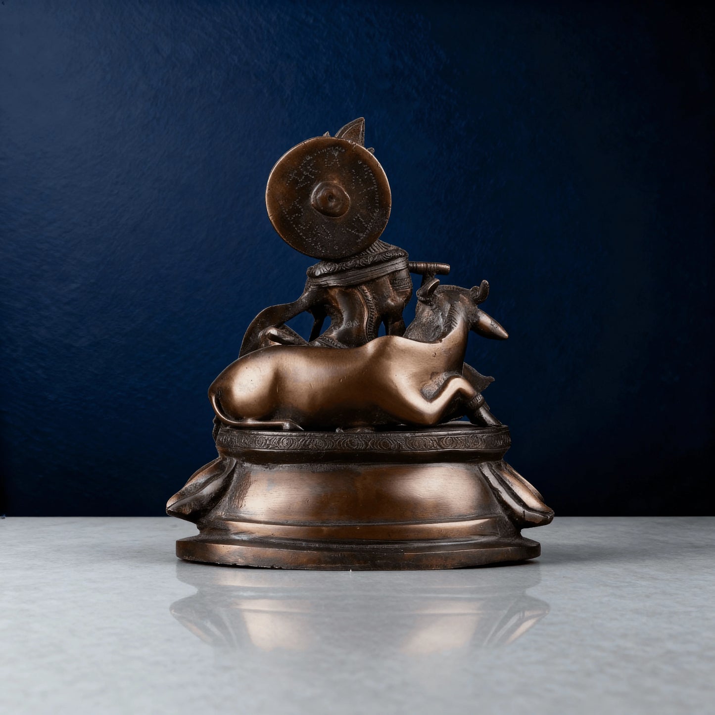 Rear view showing back design of solid brass Krishna idol and resting cow, smooth antique brass finish