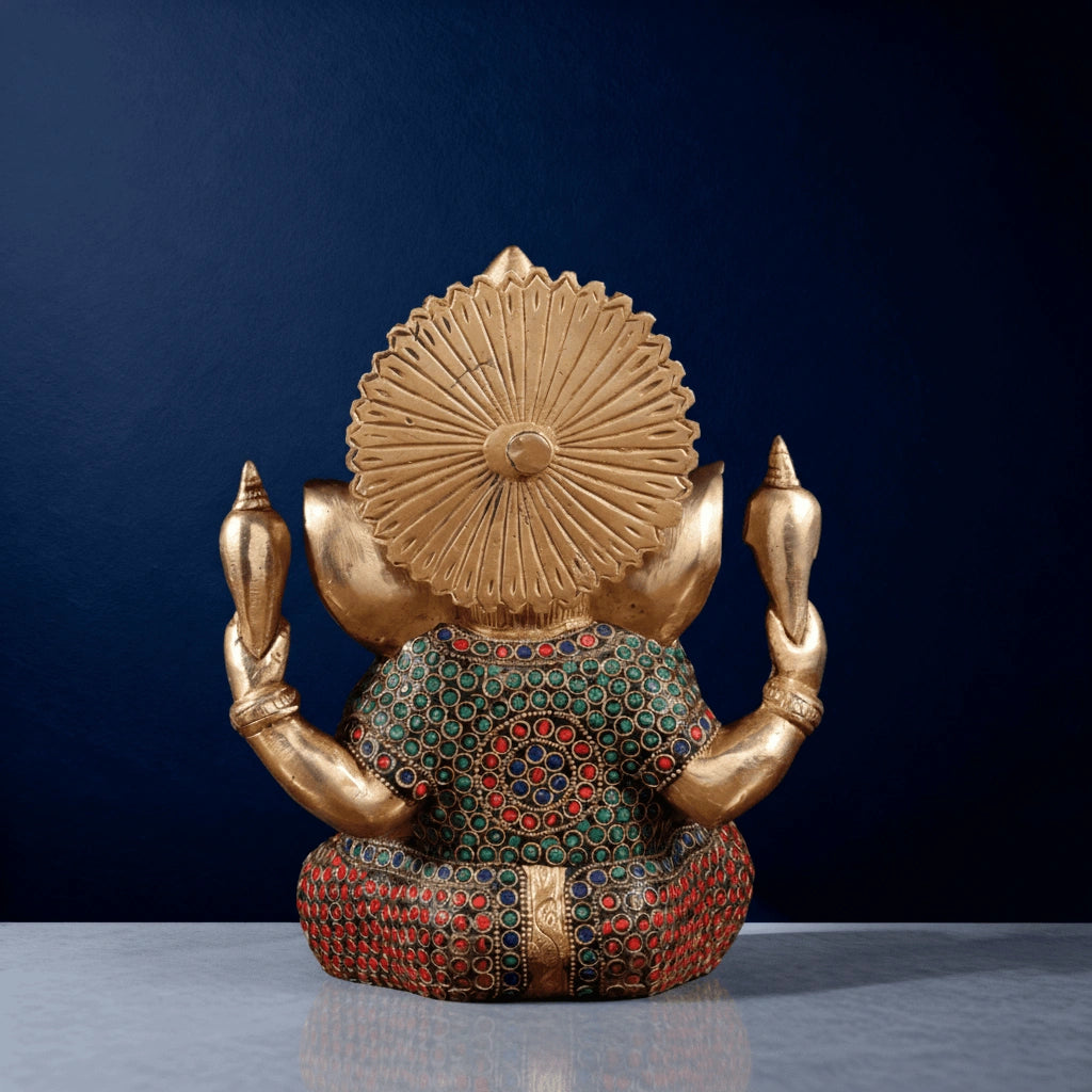 Back view of meenakari brass Ganesha idol showcasing colorful stonework and traditional Indian carving