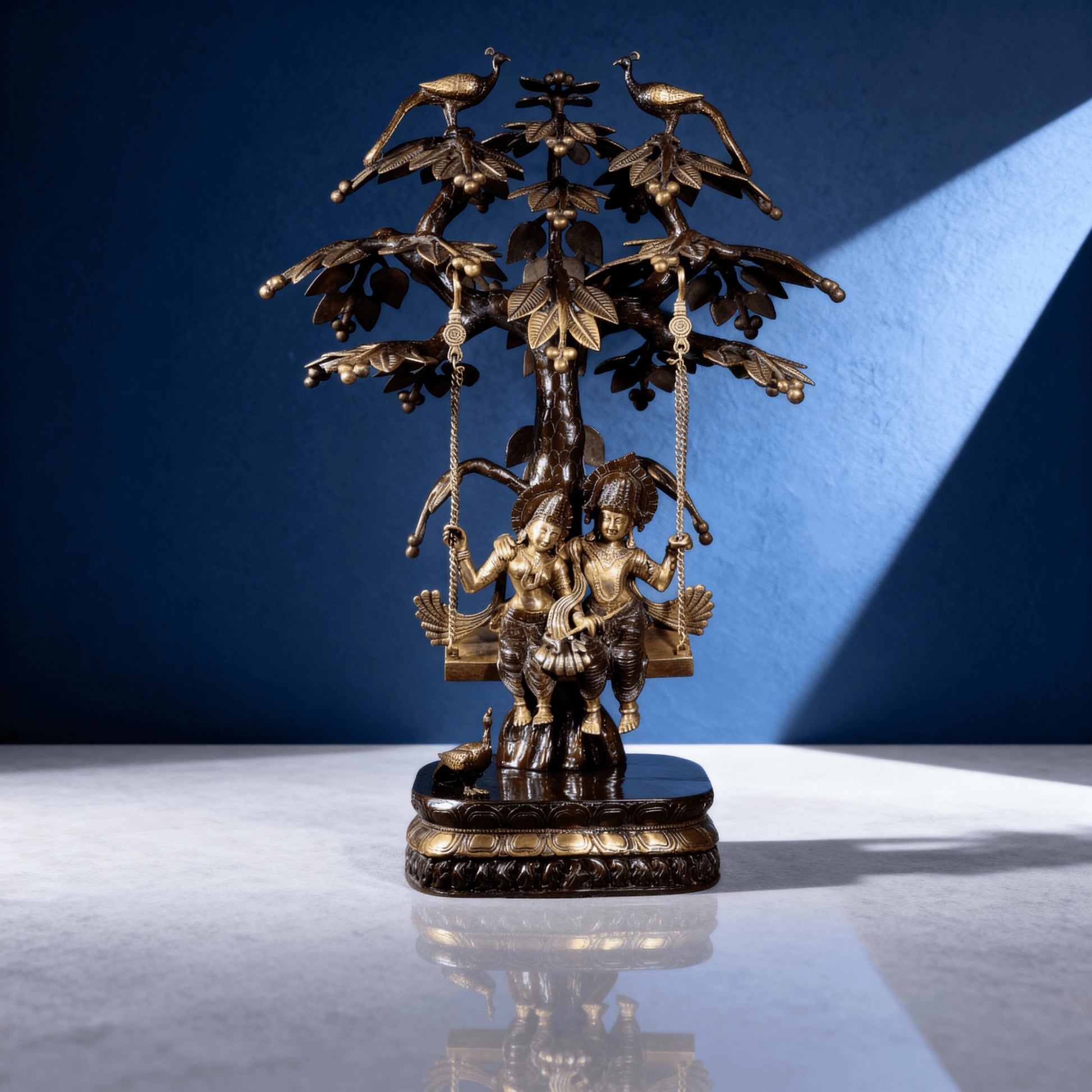 Radha Krishna brass swing idol under decorative tree with peacocks