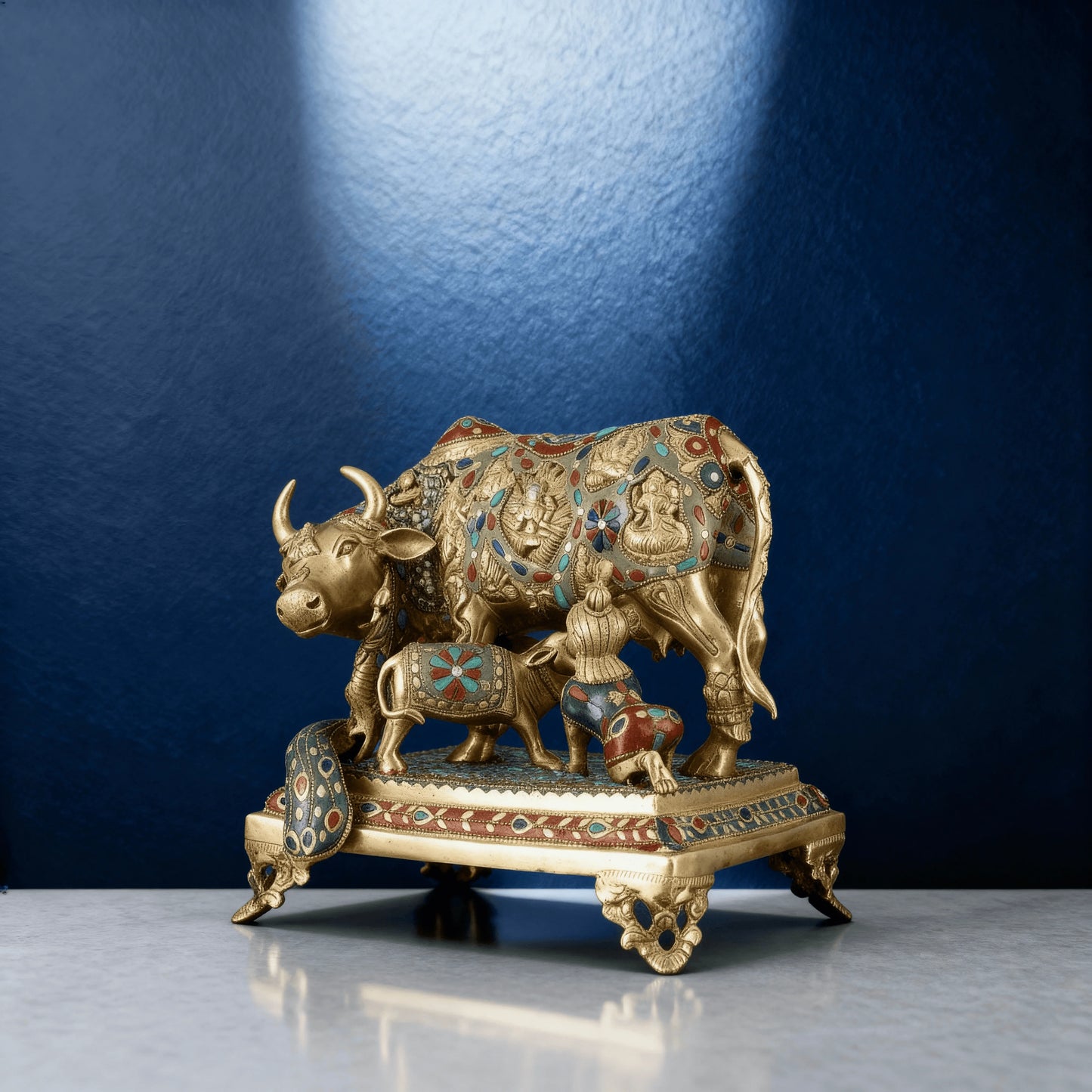 Kamadhenu cow and calf brass idol on pedestal, handcrafted with red and blue stone inlay, Indian traditional design