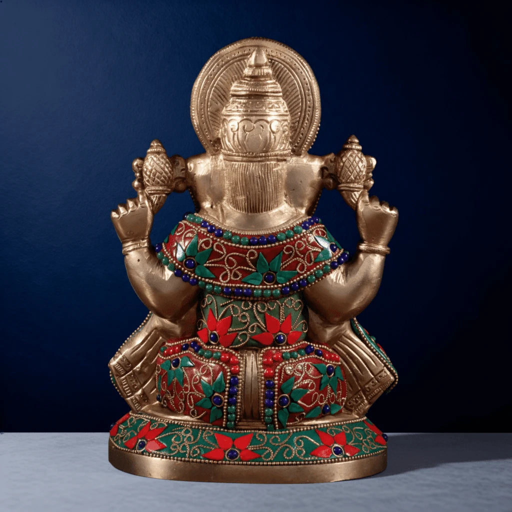Back view of handcrafted brass Ganesha statue featuring colorful meenakari inlay and detailed carvings