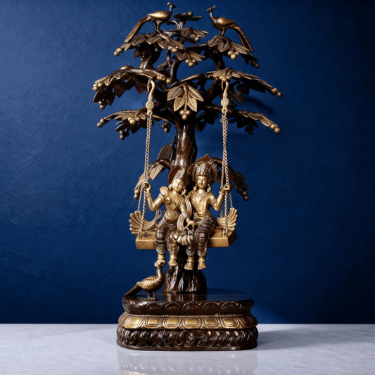 Handcrafted brass Radha Krishna jhula statue with tree and peacock detailing
