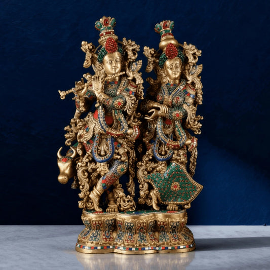 Front view of handcrafted brass Radha Krishna idol with cow, antique finish and multicolor inlay on detailed base.