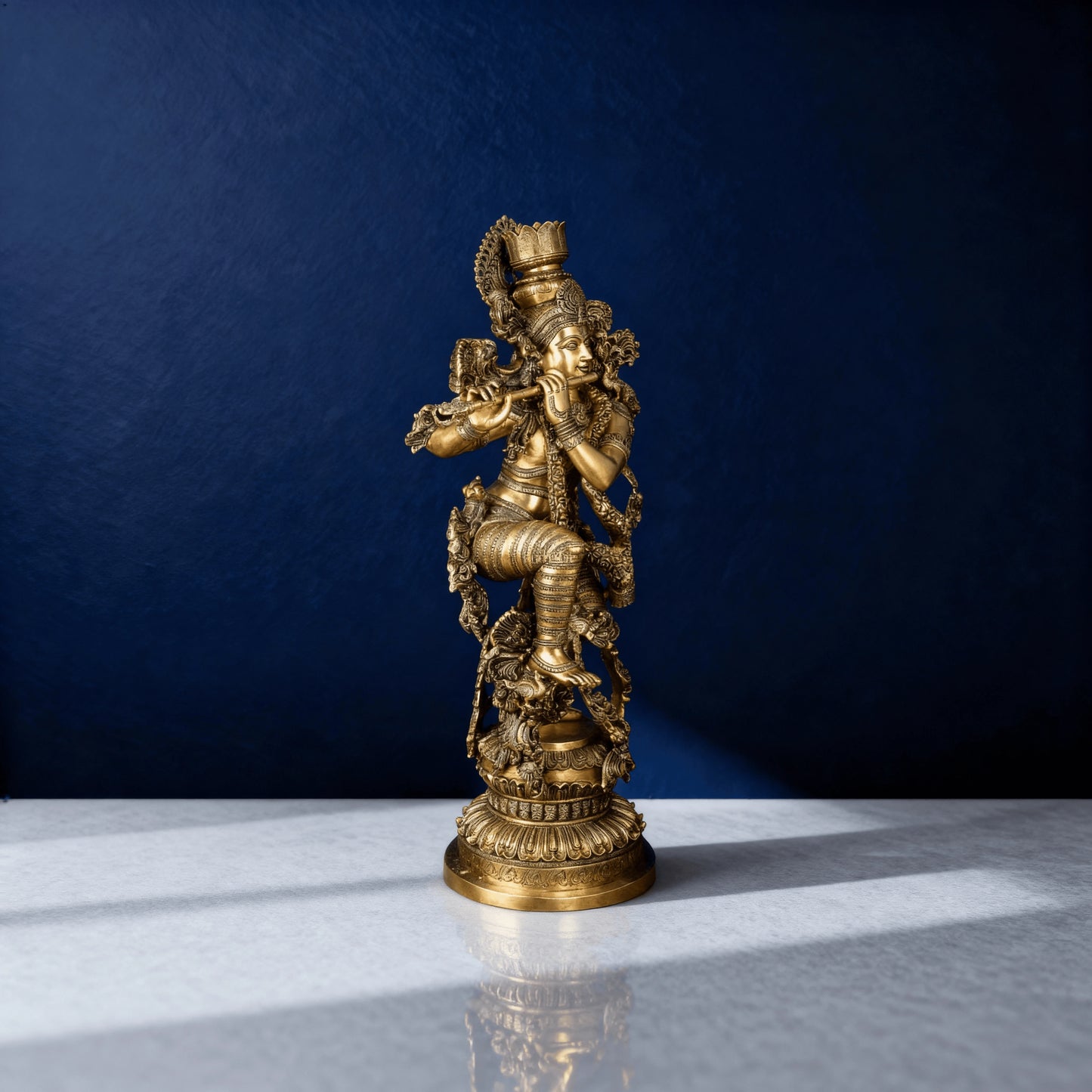 Full-view brass Krishna sculpture with carved base and traditional design
