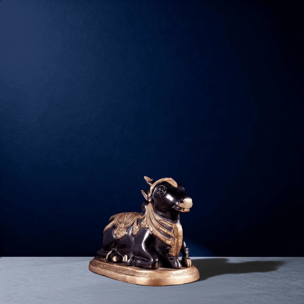 Side-angle view of handcrafted black Nandi statue with golden detailing