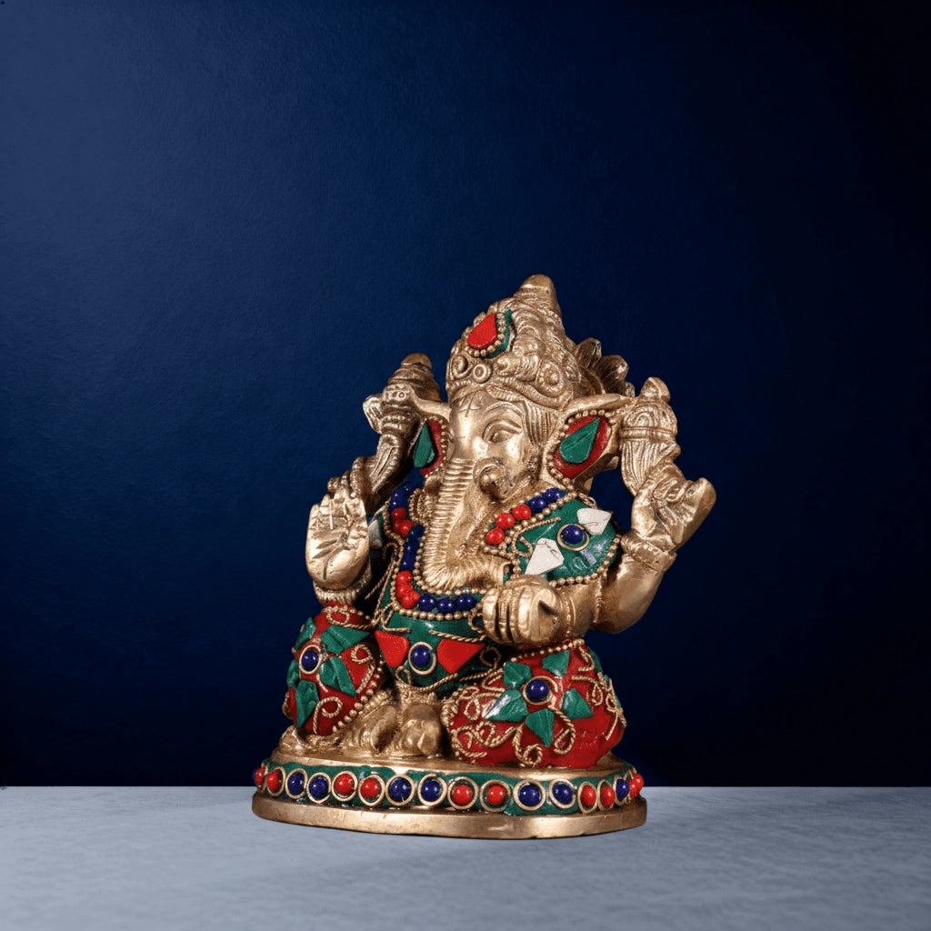 Side-angle view of multicolor stone-studded brass Ganesha statue