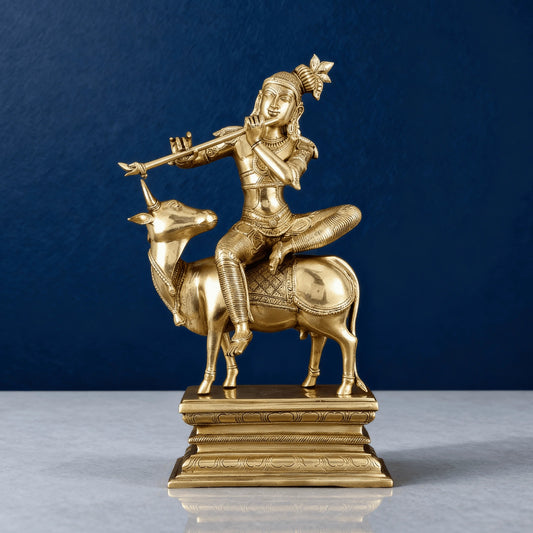 Front view of brass Krishna idol on cow, solid build with intricate details, 21-inch tall handcrafted home decor
