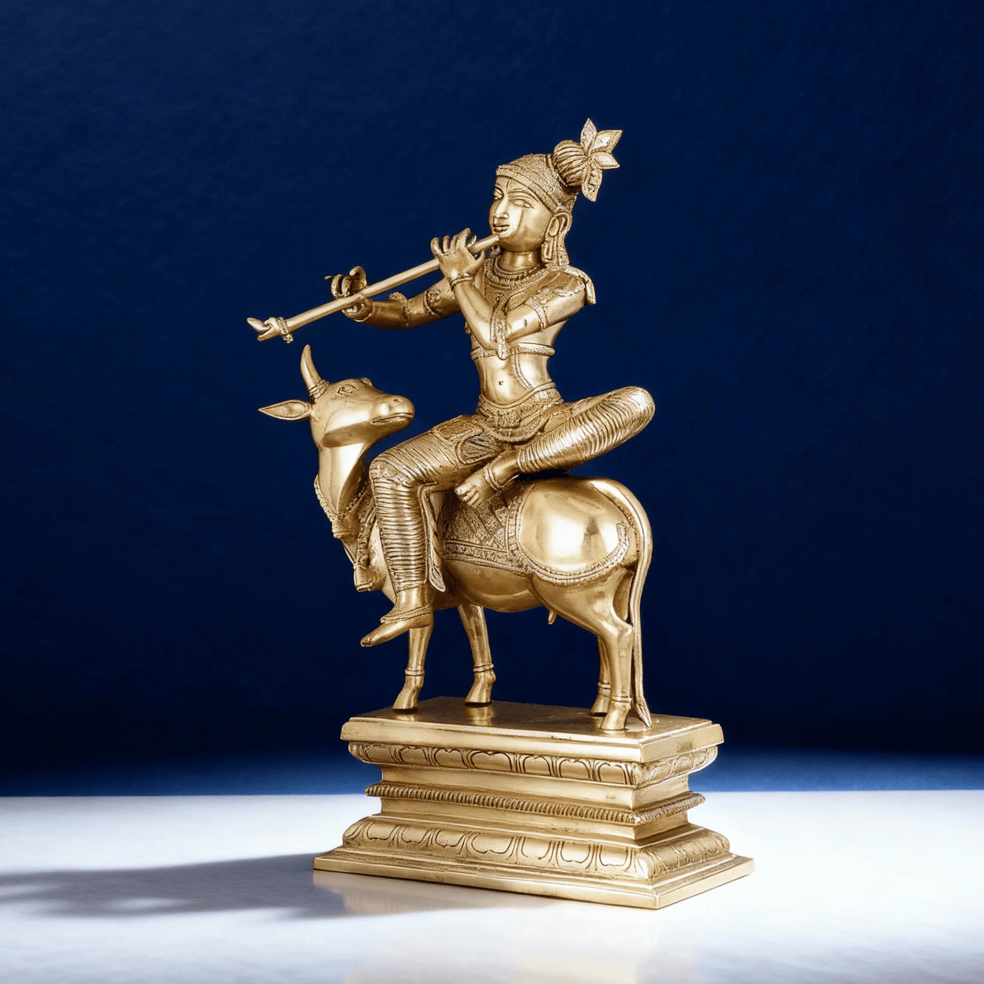 Brass Krishna seated on cow statue with flute, antique gold finish, handcrafted 21-inch sculpture on pedestal base