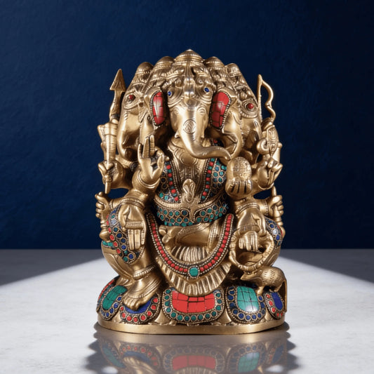 front angled view of brass ganesha idol with colorful stone detailing