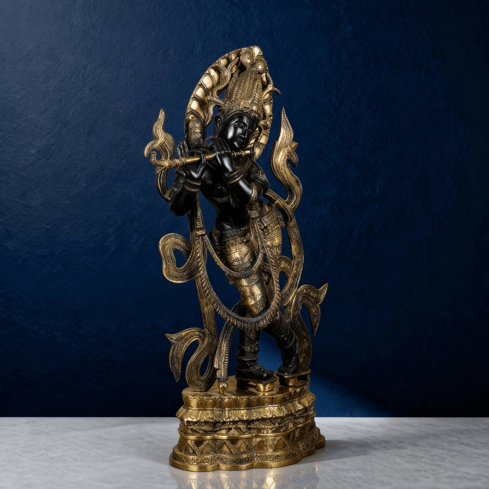 Premium brass Krishna statue with detailed carvings and halo – right side view on blue background