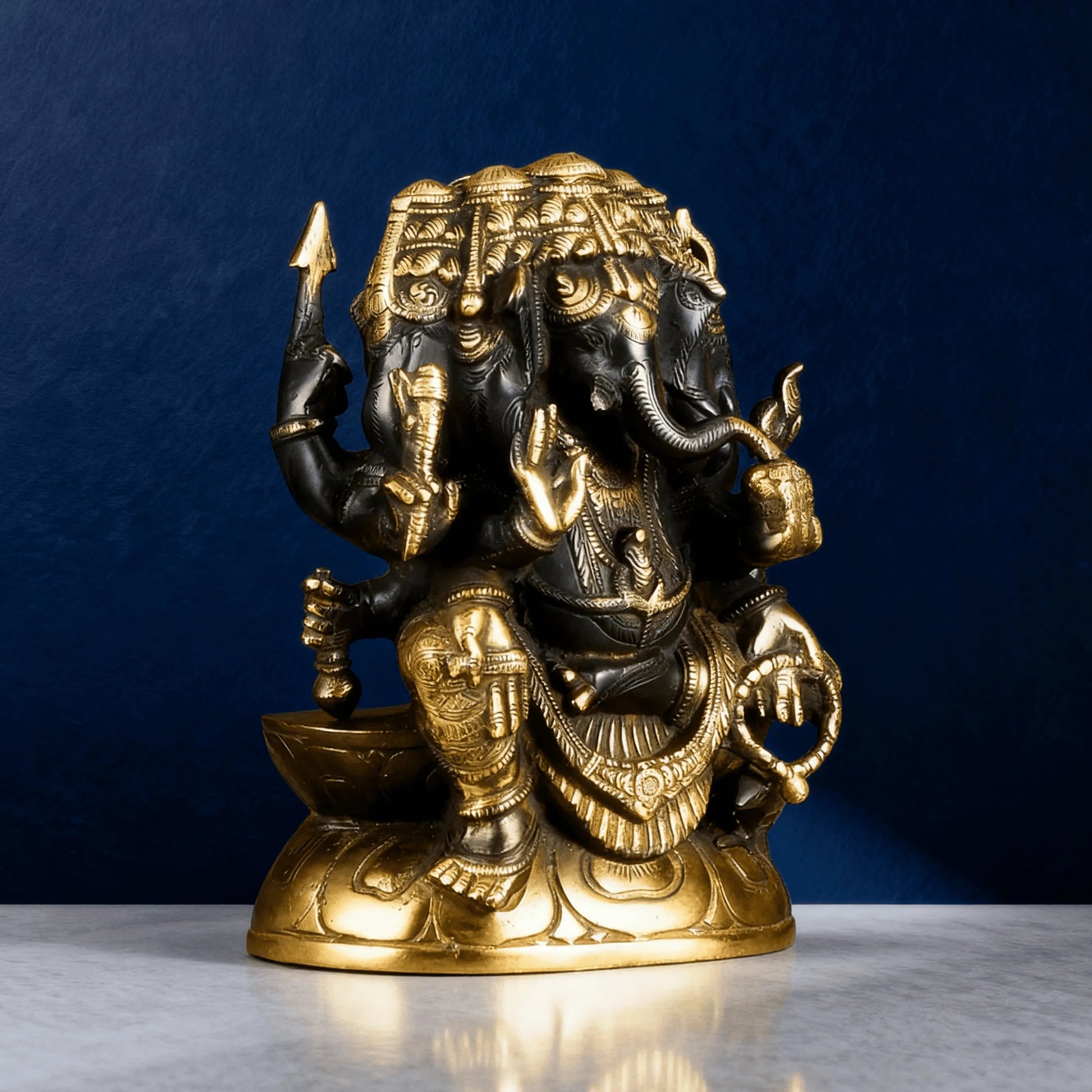 side angle black brass ganesha statue with gold detailing