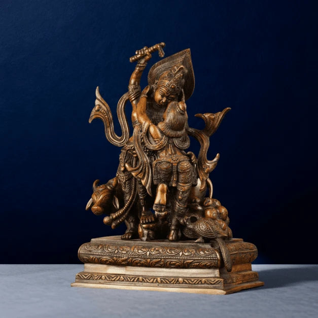 Artistic brown brass Krishna lifting Govardhan sculpture showing ornate carvings, cow and peacock details, handcrafted traditional design.