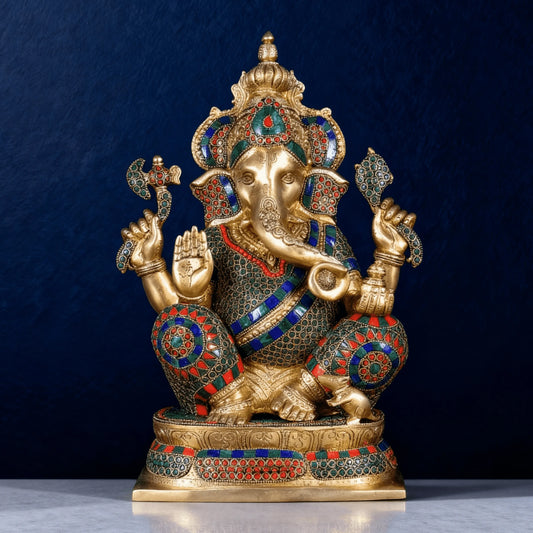 Front view of premium brass Ganesha statue with gemstone inlay work, seated posture with raised blessing hand on marble surface