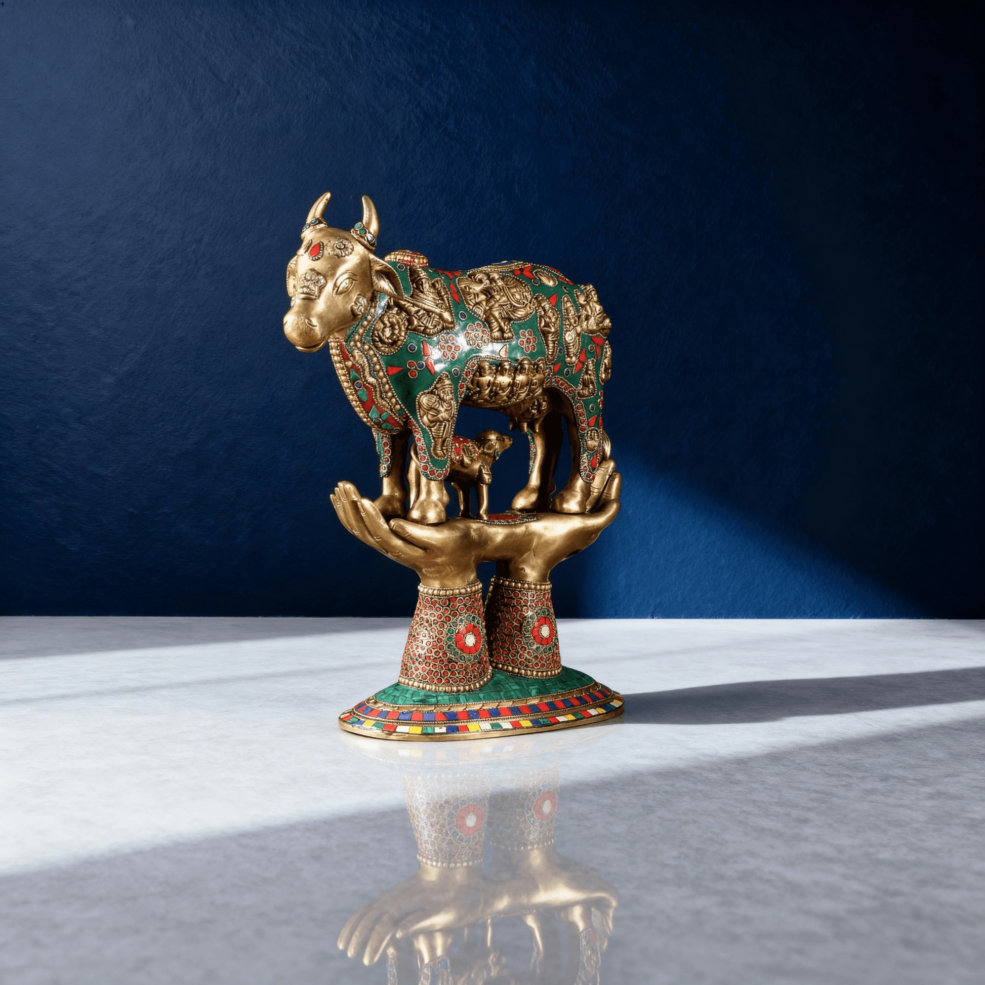 Brass Kamadhenu cow idol with colorful meenakari work on raised hands – sacred Hindu decor for home or office