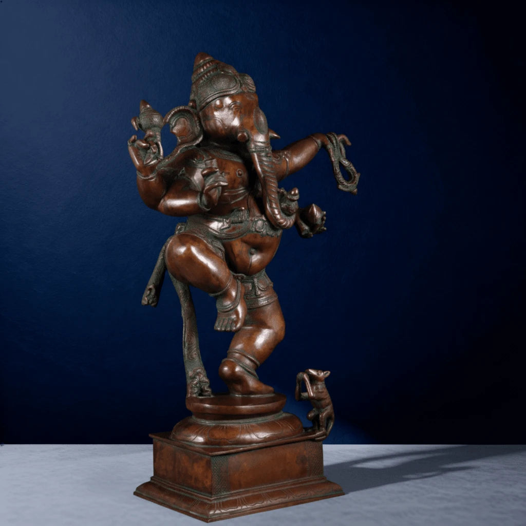 Close-up angled view of antique dancing Ganesha murti with detailed features and companion mouse