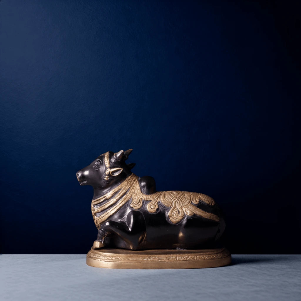 Brass Nandi idol in black finish with ornate carvings on a gold base