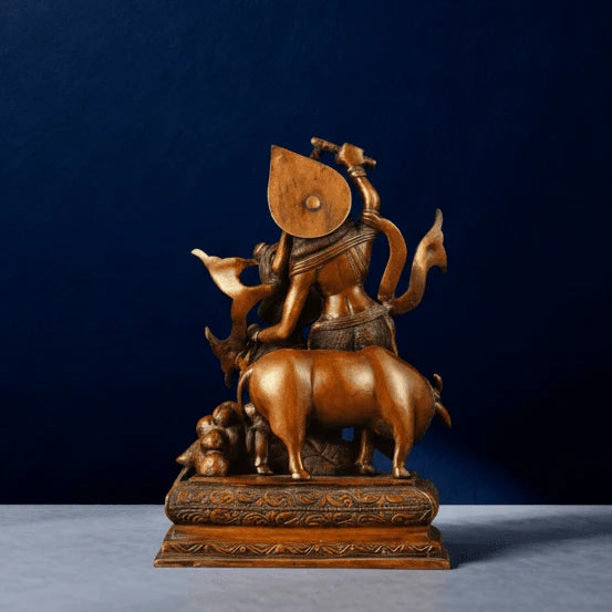 Handcrafted brown brass Krishna lifting Govardhan statue back view on marble surface, detailed cow and peacock carving, premium home decor piece.