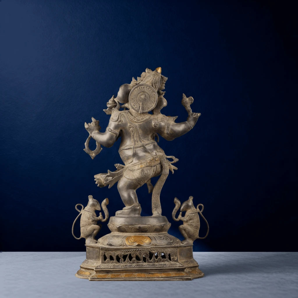 Rear view of silver antique dancing Ganesha statue with ornate detailing and twin mice on pedestal
