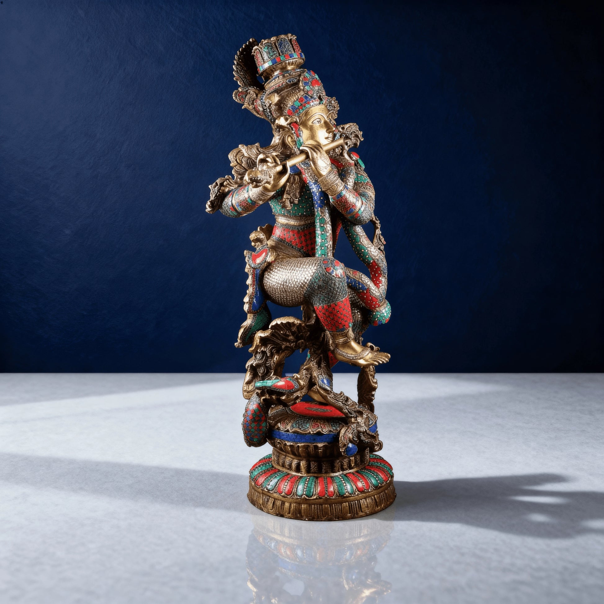 Side view of handcrafted stone-work brass Krishna statue