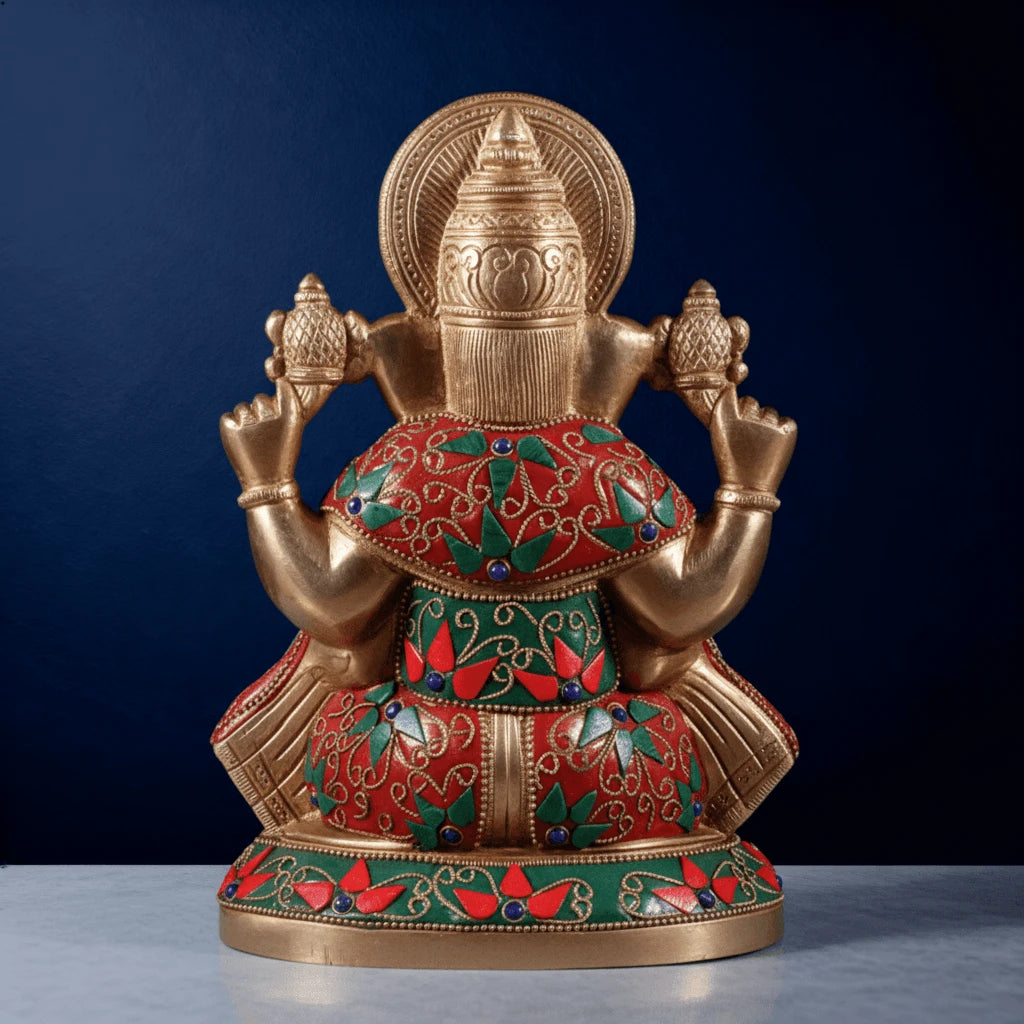 Back view of meenakari brass Ganesha idol with red and green stone inlay and intricate handcrafted detailing