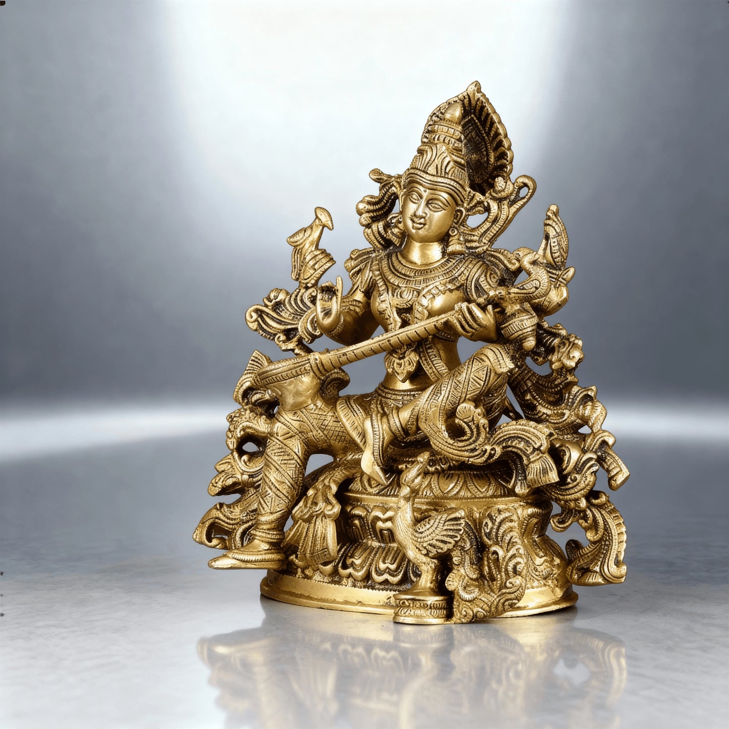 close-up view of handcrafted brass Saraswati statue highlighting the intricate veena, ornaments, and fine sculpting