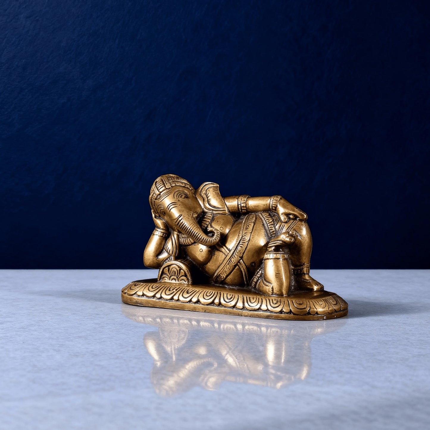 angled view resting ganesha brass idol for pooja and decor
