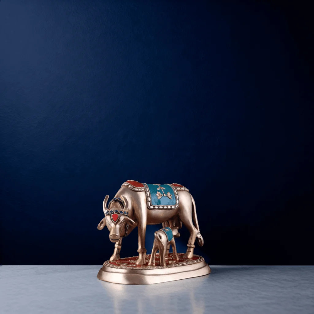 Side view of brass cow and calf figurine adorned with gemstone and enamel work – sacred Hindu decorative showpiece