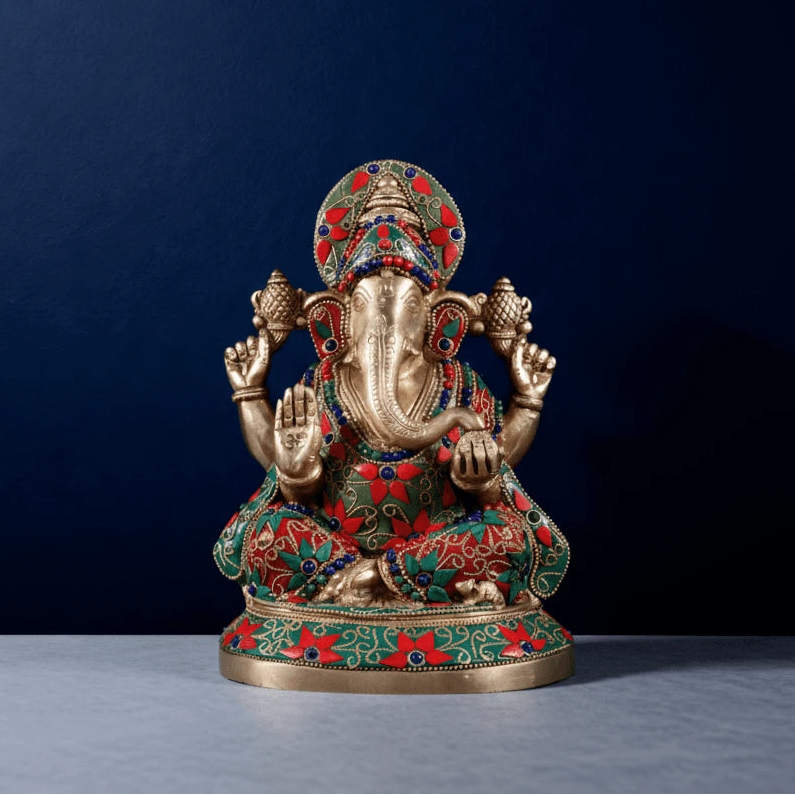 Front view of meenakari brass Ganesha idol with red and green stonework for home decor and pooja room