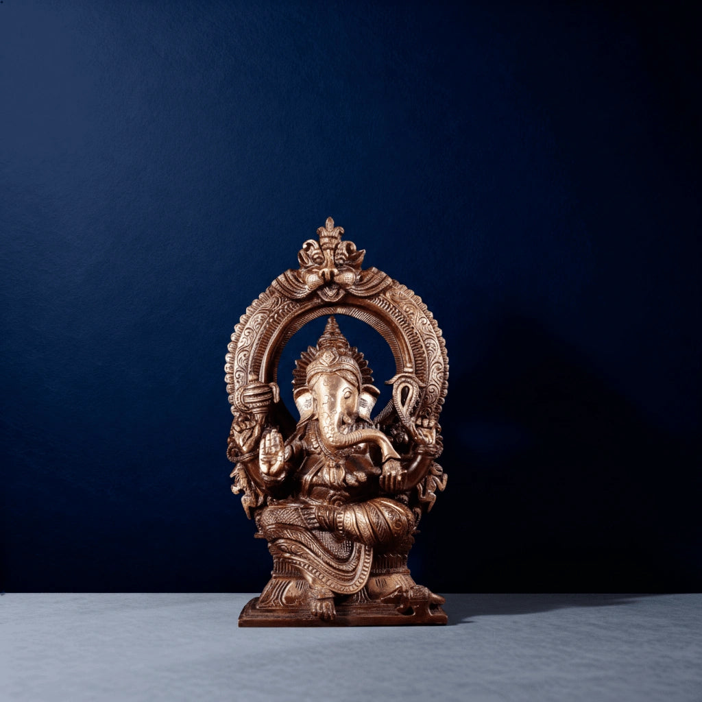 Front view of antique brass Ganesha statue with intricate hand-carved arch and detailed craftsmanship