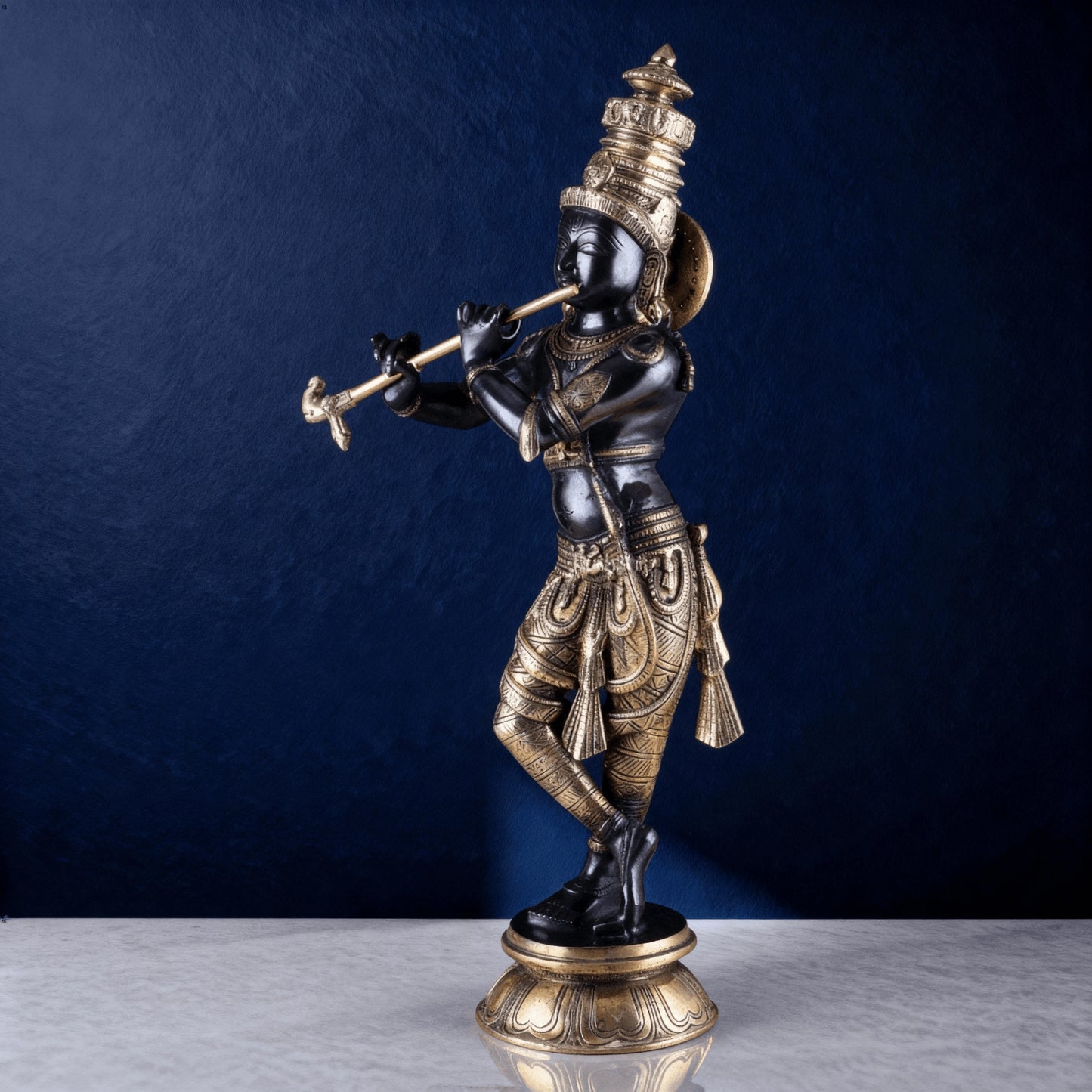 Handcrafted black and gold Krishna idol playing flute for home decor