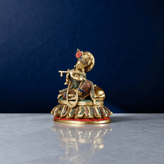 Brass Krishna statue playing flute, seated posture with multicolor stone detailing and intricate handwork