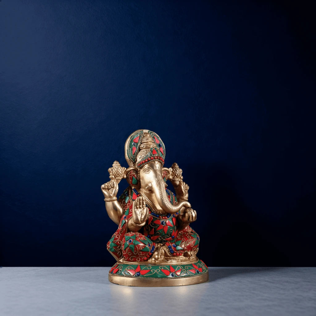 Side-angle shot of handcrafted meenakari brass Ganesha statue featuring colorful stonework and premium carving