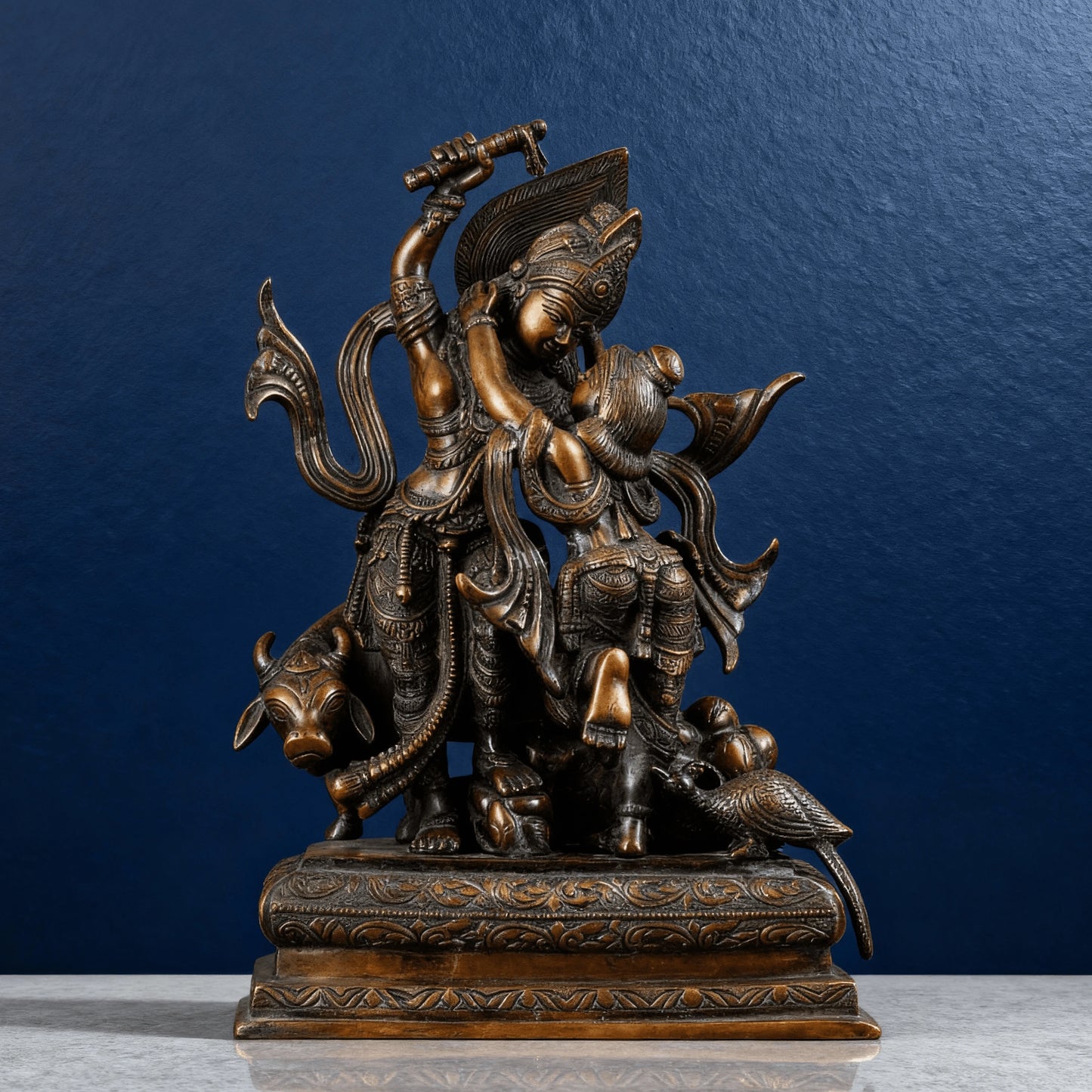 High-quality brown brass Krishna lifting Govardhan idol on carved base, detailed textures and motifs, handcrafted Indian artwork.