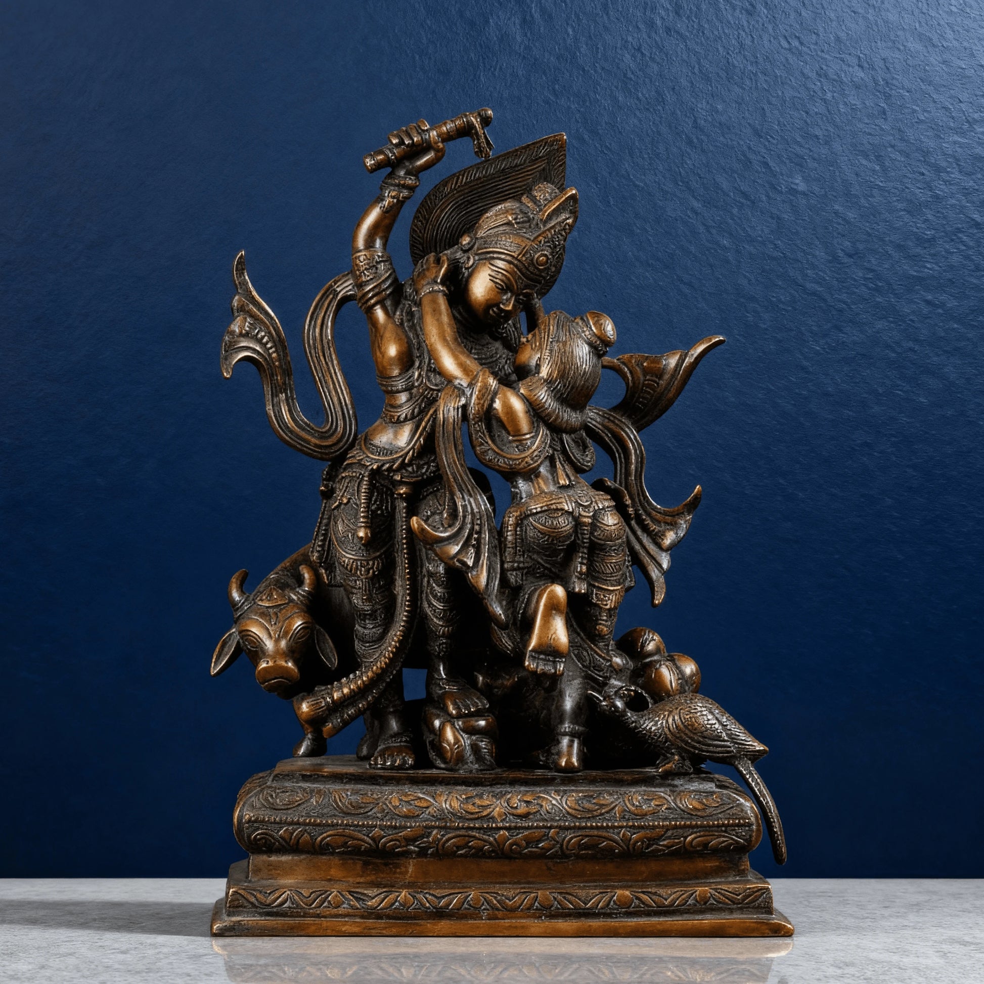 High-quality brown brass Krishna lifting Govardhan idol on carved base, detailed textures and motifs, handcrafted Indian artwork.