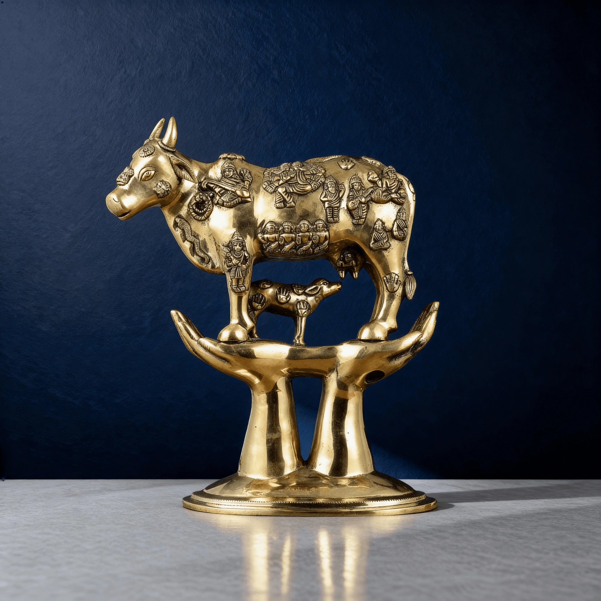 Close-up of sacred Kamadhenu cow statue with miniature gods and calf – handcrafted brass home temple decor