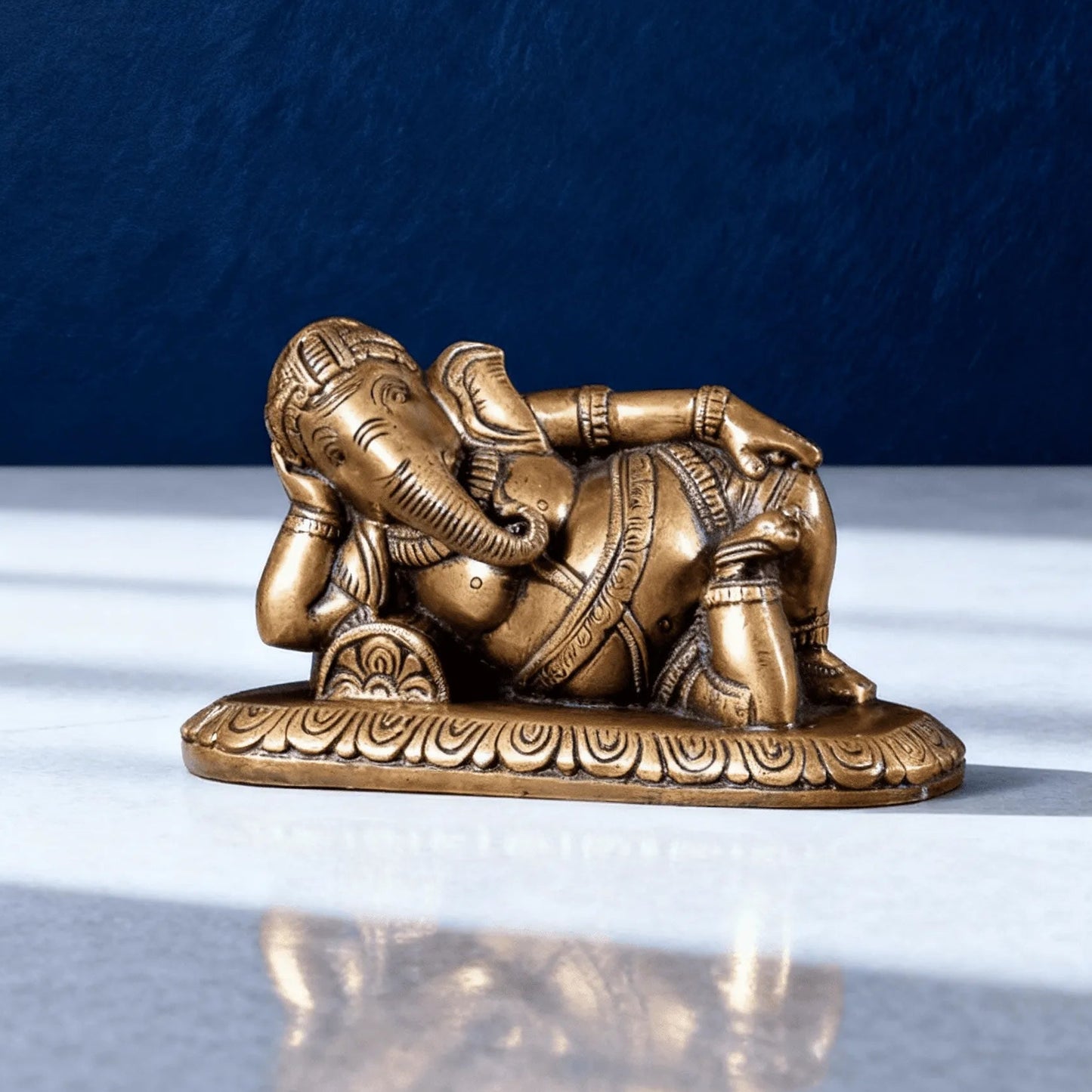 small reclining brass ganesha idol for home decor