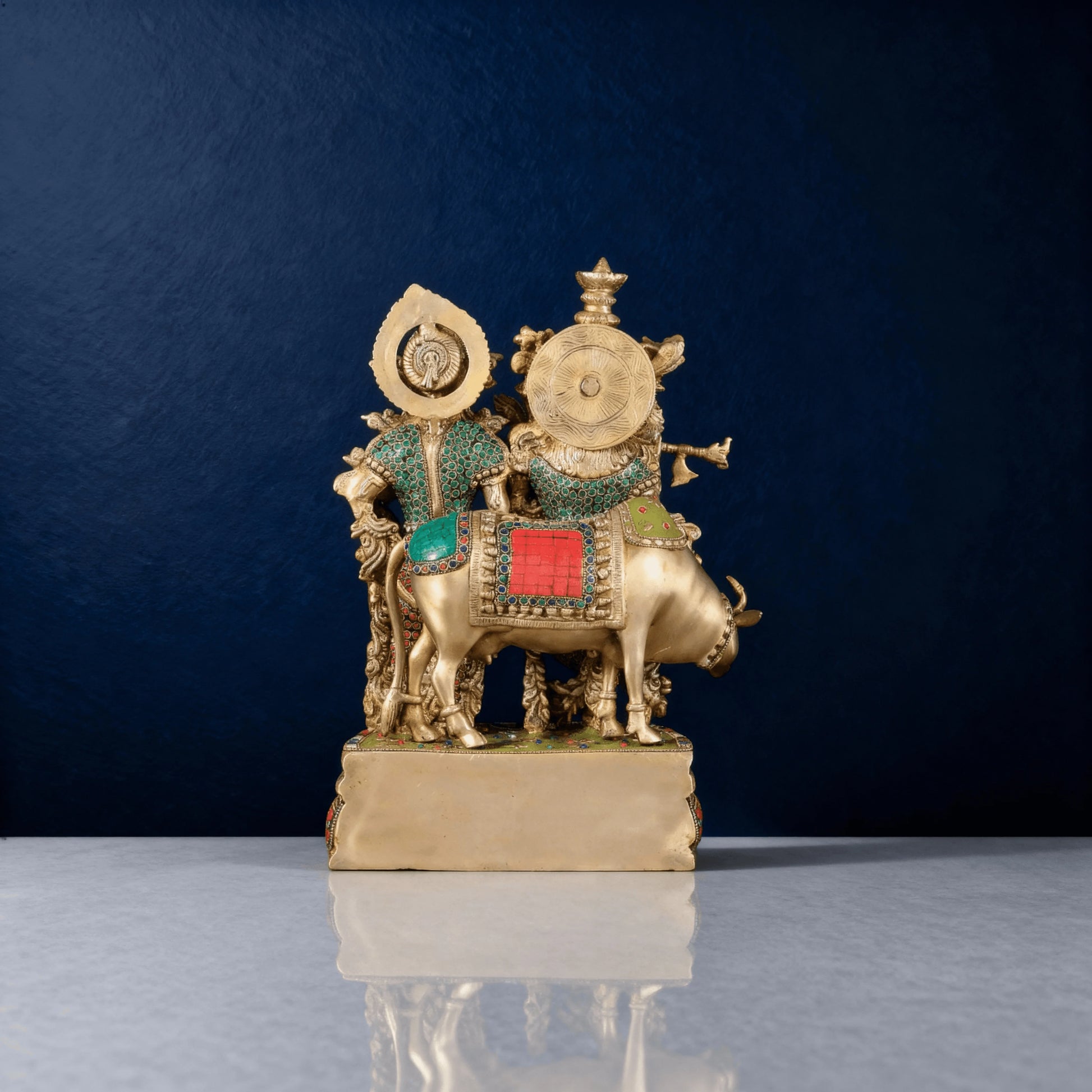 Back view of Radha Krishna brass idol seated on cow with ornate detailing – religious home temple statue