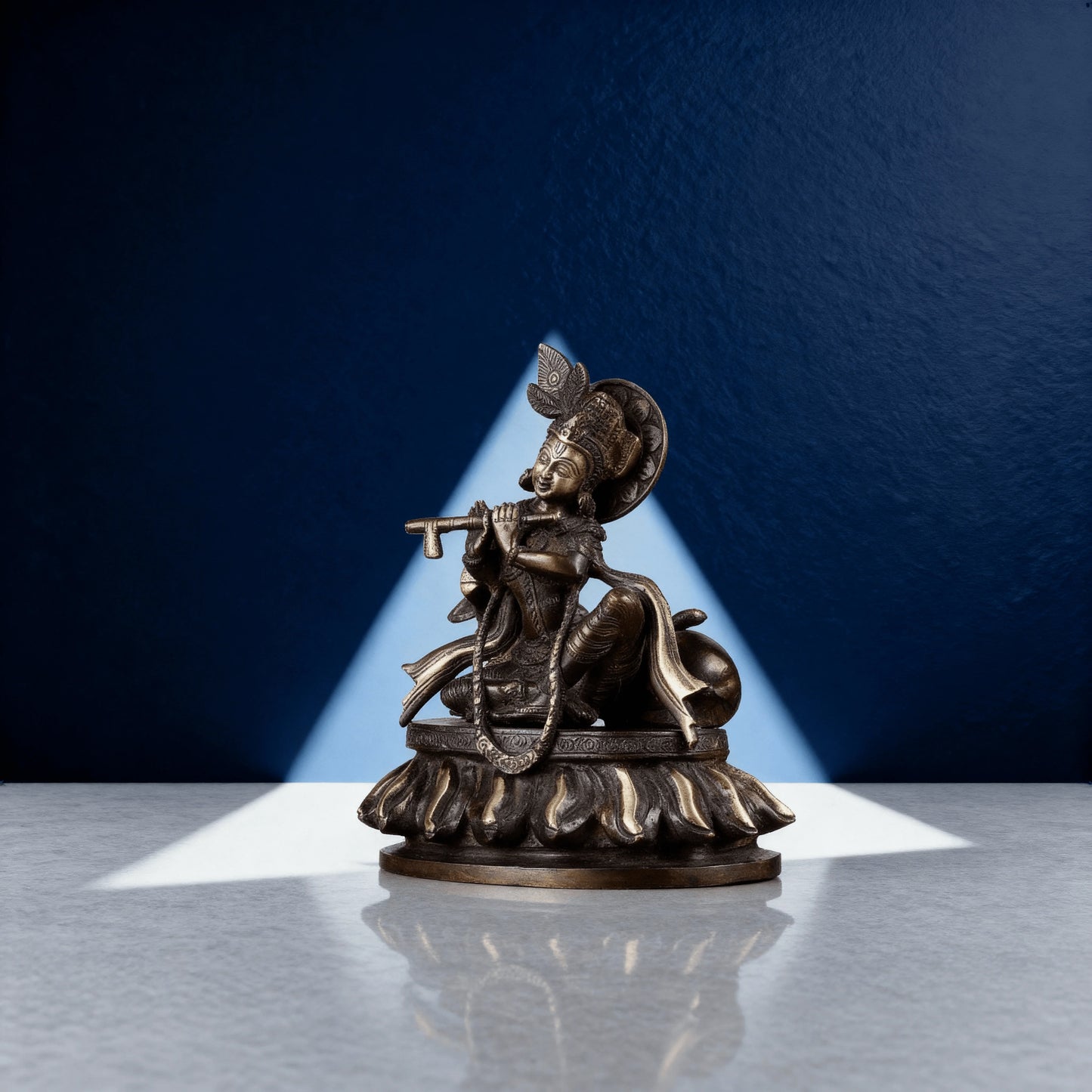 Side profile of Krishna brass statue with flute and cow, handcrafted with intricate detailing, 8.5 inches tall