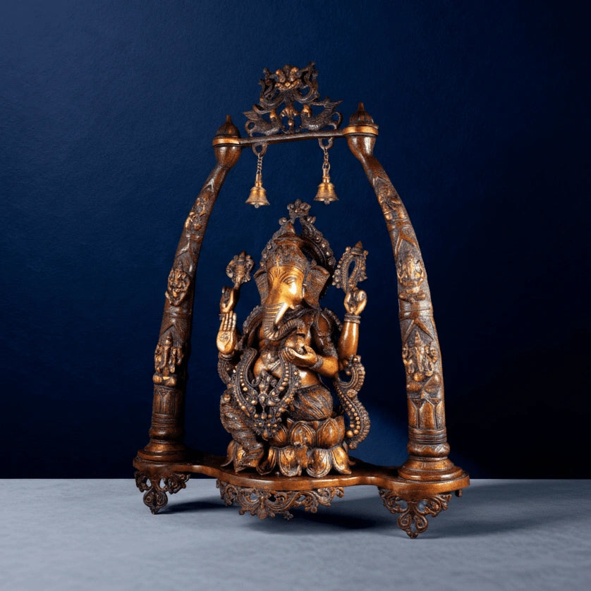Side-angle view of brass Ganesha swing idol showing intricate detailing and carved arch frame