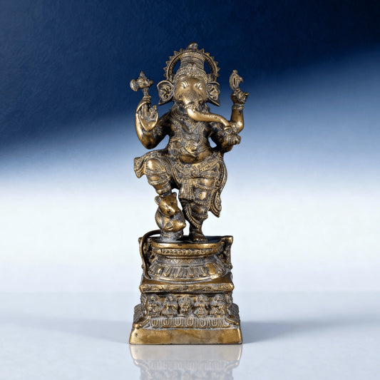 Front view of dancing brass Ganesha idol on ornate pedestal for home decor and temple worship