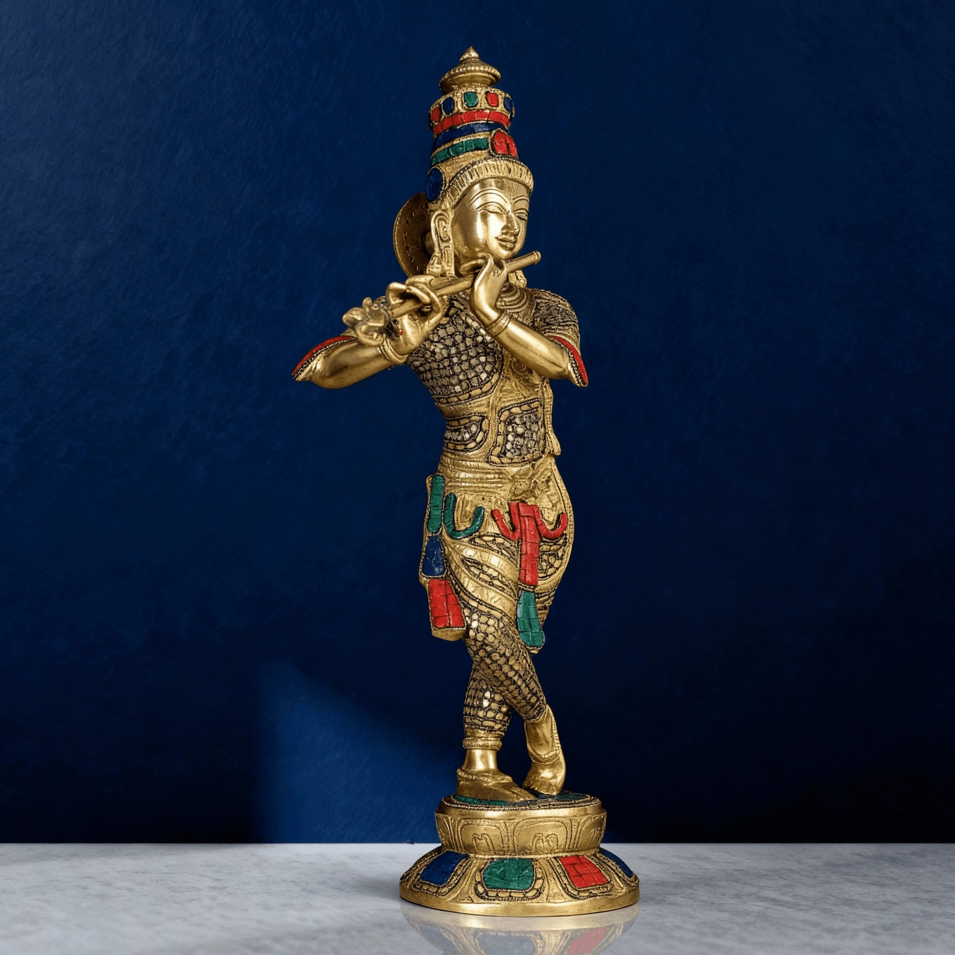 Front view of brass Krishna statue playing flute with detailed meenakari work