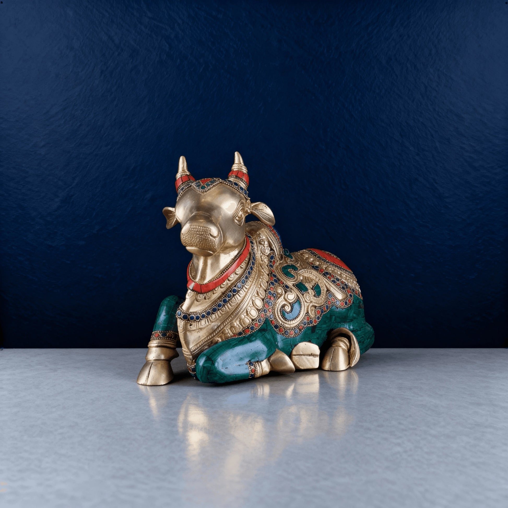 Front view of sitting brass Nandi statue featuring intricate gemstone work and antique detailing, handcrafted by Aarvya artisans.