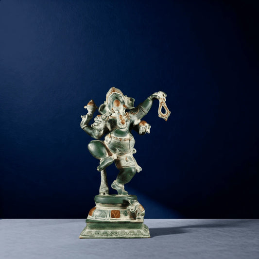Front view of antique green finish Lord Ganesha sculpture in dancing pose with ornate detailing