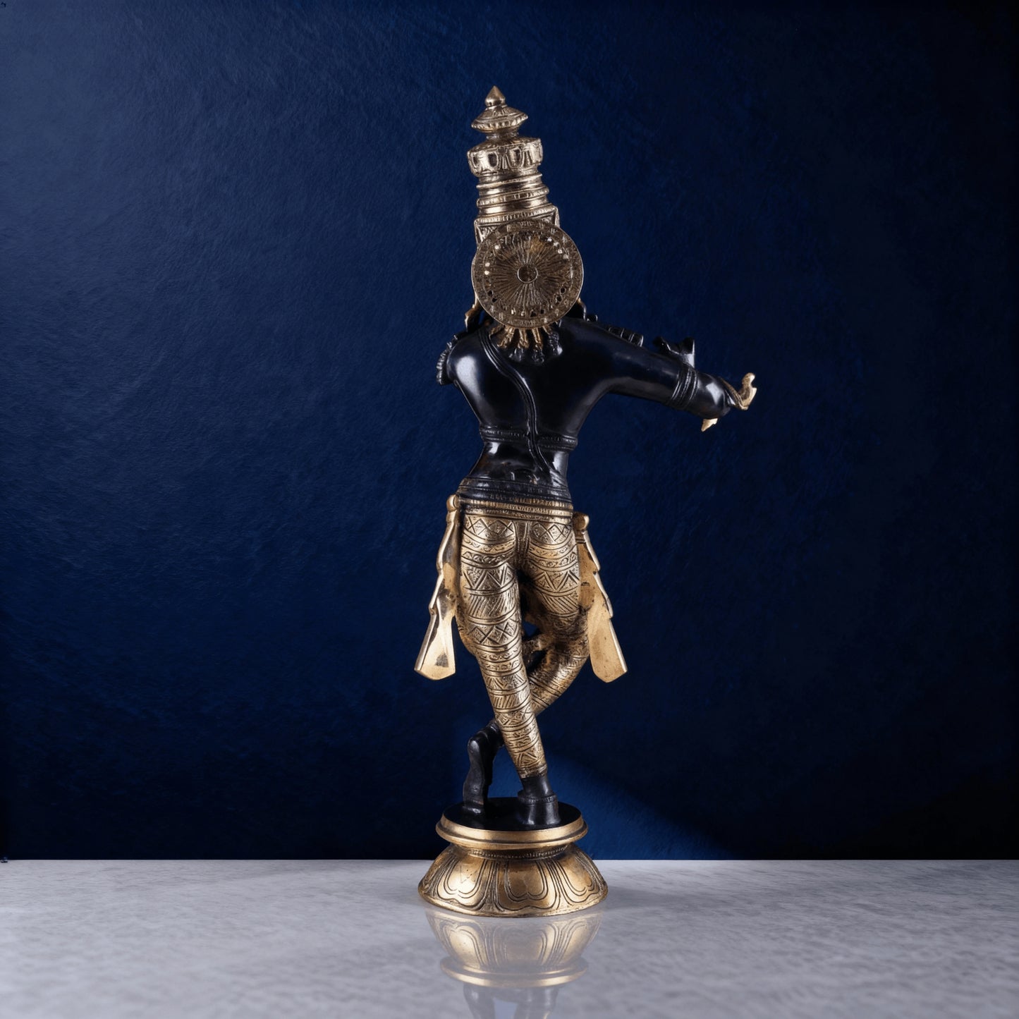 Back view of black brass Krishna statue with detailed engraving