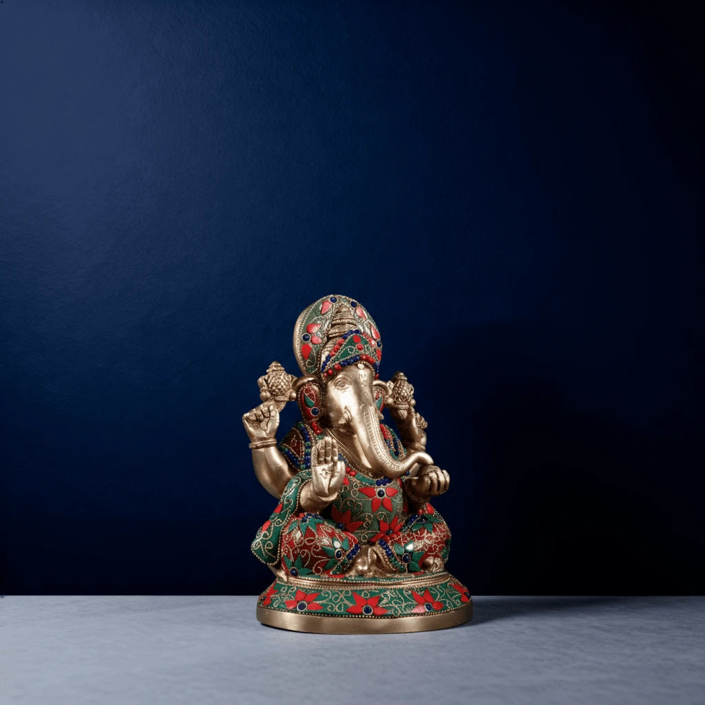 Three-fourth angle of meenakari brass Ganesha statue with decorative stone inlay for spiritual home decor