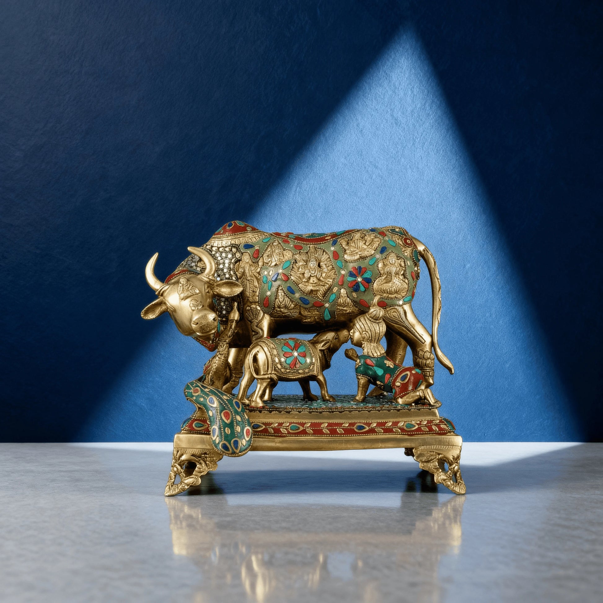 Front view of 14-inch Kamadhenu brass idol with multicolor stone inlay and handcrafted pedestal, suitable for home decor