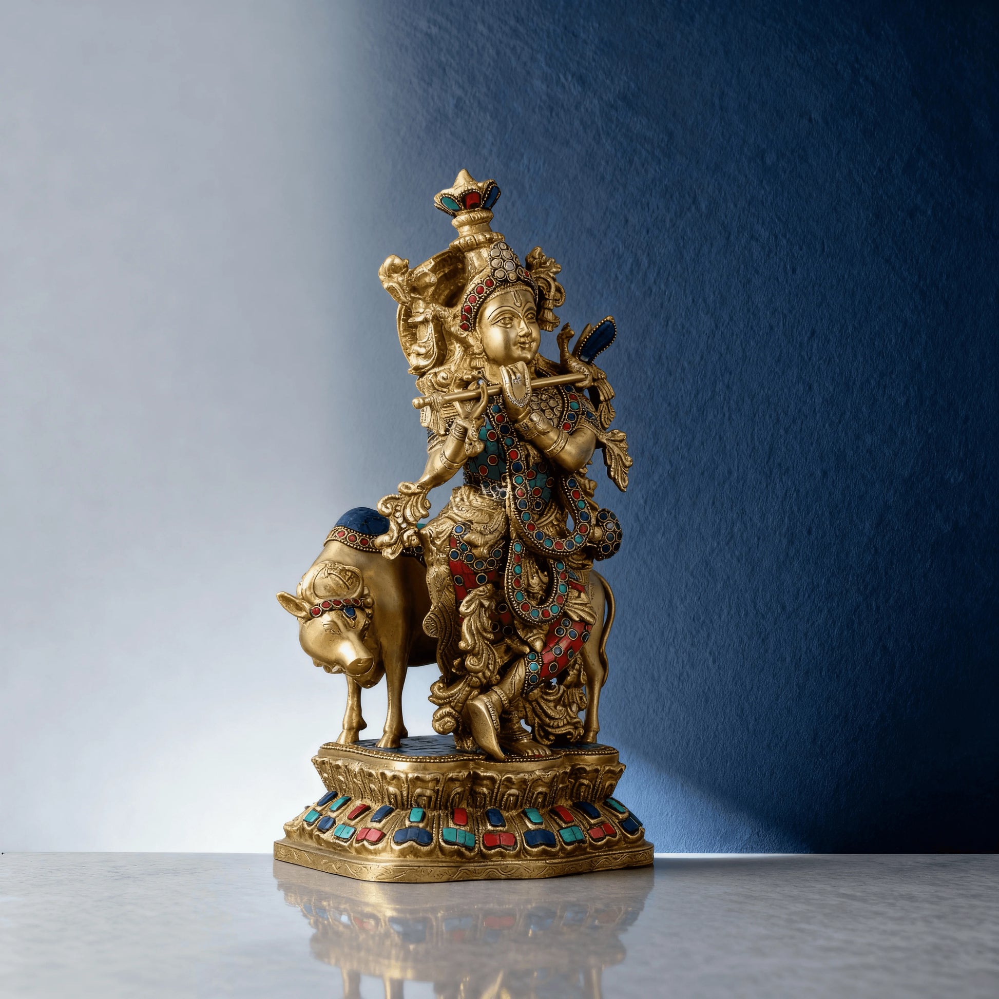 Detailed side view of Krishna with cow brass statue, handcrafted with gemstone accents and intricate carvings