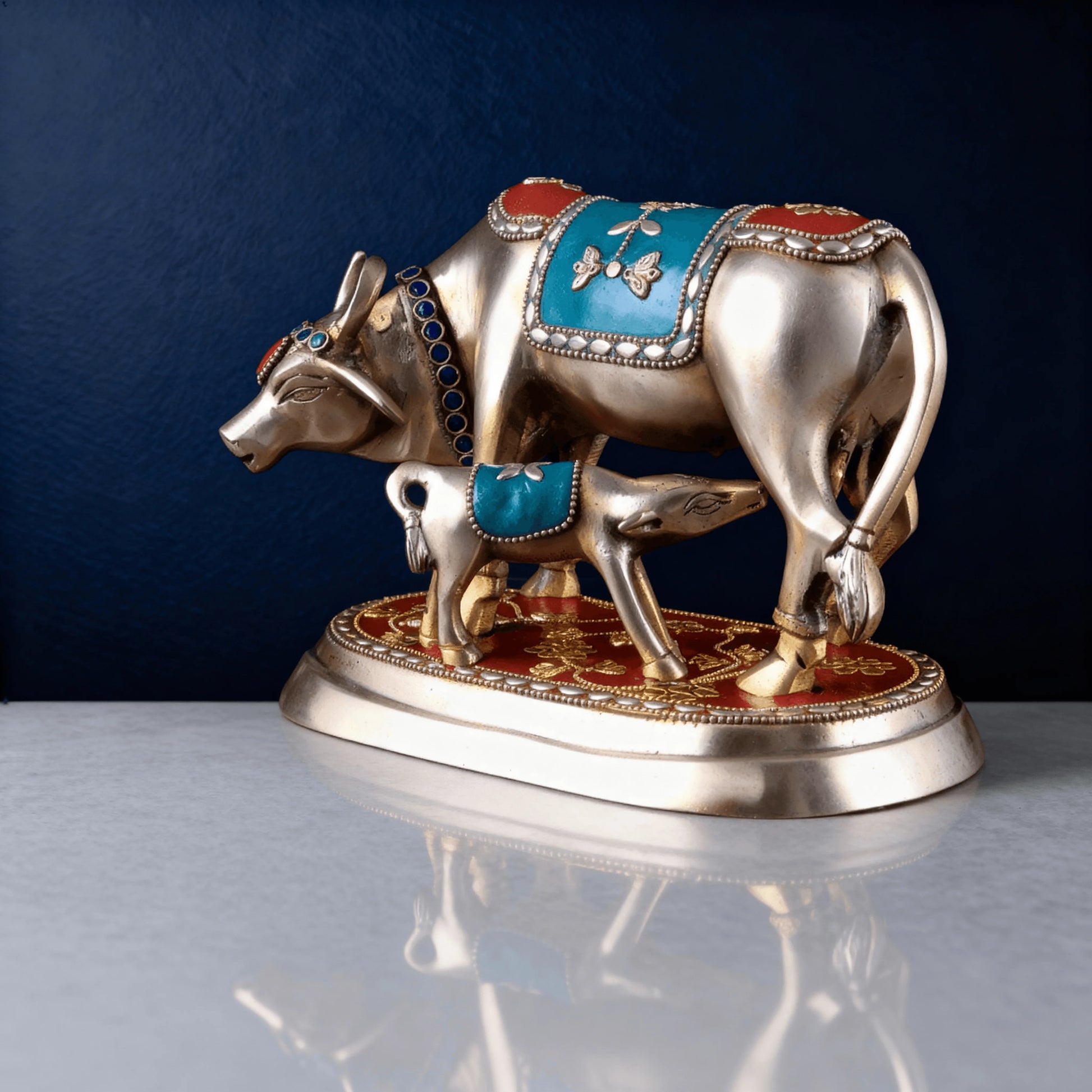 Handcrafted brass Kamadhenu cow and calf statue with blue and red stone inlay – spiritual gift or pooja decor item